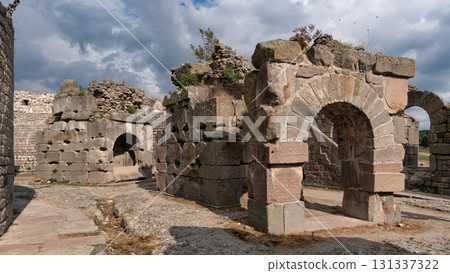 Ancient stone ruins and arches of Pergamon Acropolis under a cloudy sky, Bergama, Turkey Ancient stone ruins and arches of Pergamon Acropolis under a cloudy sky, Bergama, Turkey 131337322