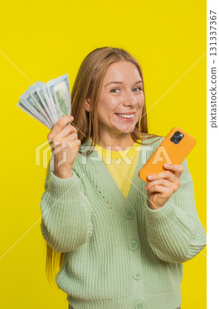 Happy woman use smartphone rejoicing game win, receiving money dollar cash, celebrating success 131337367