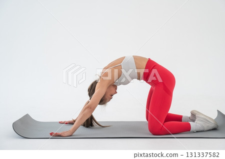 Caucasian woman doing sports exercises on white background.  131337582