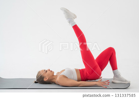 Caucasian woman doing sports exercises on white background.  131337585