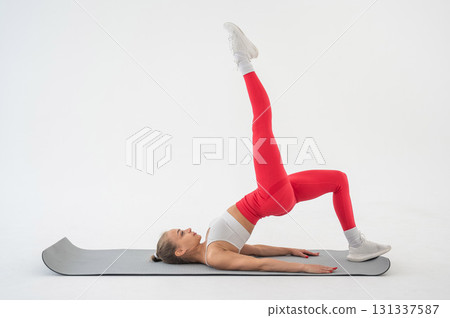 Caucasian woman doing sports exercises on white background. Caucasian woman doing sports exercises on white background. 131337587