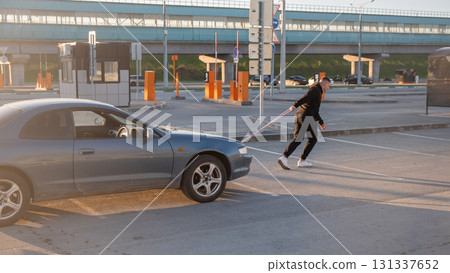 Caucasian man pulling a car with a rope.  131337652