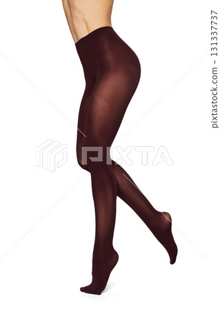 Beautiful long fit female legs in burgundy tights on white background 131337737