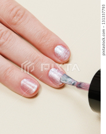manicure in a beauty salon or at home, a woman paints her nails. manicure in a beauty salon or at home, a woman paints her nails. 131337793