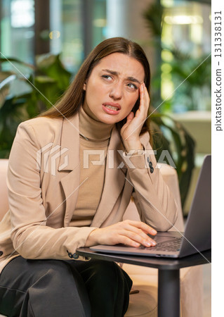Tired businesswoman freelancer use laptop suffering from headache problem tension migraine stress 131338131
