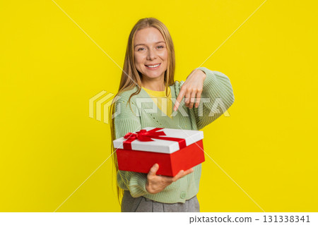 Smiling woman presenting birthday gift present box stretches out hands, promotion discount sale Smiling woman presenting birthday gift present box stretches out hands, promotion discount sale 131338341