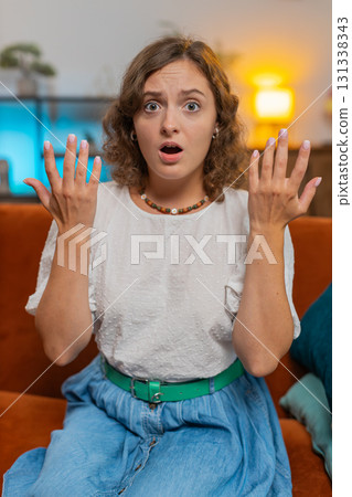Young woman feeling hopelessness and loneliness, nervous breakdown, loses play sitting on sofa couch 131338343