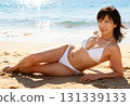 一位身穿泳衣的中年婦女在海灘上放鬆的肖像 131339133