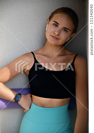 Young woman confidently posing in a fashionable outfit against a contemporary backdrop, highlighting her unique style and vibrant personality Young woman confidently posing in a fashionable outfit against a contemporary backdrop, highlighting her unique style and vibrant personality 131340040