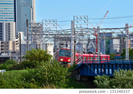 Aichi Prefecture: Nagoya Cityscape: Nagoya Station buildings and Meitetsu trains seen from the Shonai River riverbed 131340337