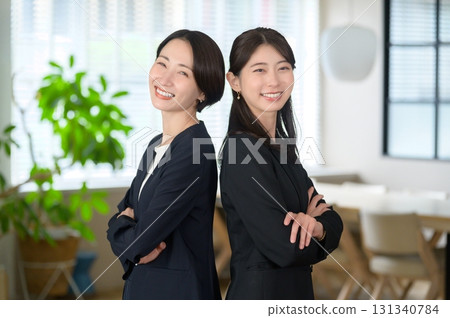 Japanese women standing in a row in the office, arms crossed, looking at the camera Japanese women standing in a row in the office, arms crossed, looking at the camera 131340784