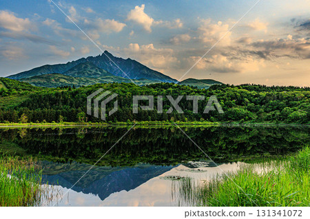 Rishiri Fuji surrounded by clouds and its reflection on the lake surface Rishiri Fuji surrounded by clouds and its reflection on the lake surface 131341072