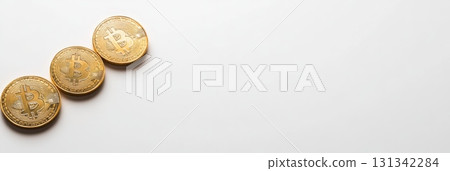 Three shiny golden bitcoins are arranged diagonally on a clean white background, symbolizing cryptocurrency investment, finance, and the growing digital economy 131342284
