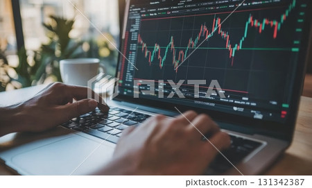 Stockbroker is analyzing cryptocurrency investment using laptop while enjoying coffee in a cafe, showcasing the intersection of finance and technology 131342387