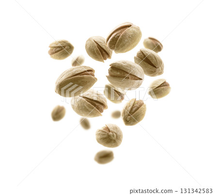 Salted pistachios levitate on a white background 131342583
