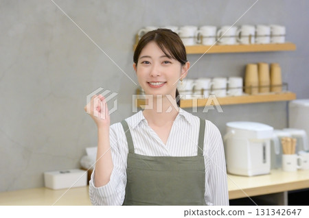 Female staff doing a fist pump 131342647