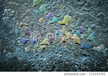 Oil spill creating colorful abstract pattern on asphalt. Oil spill creating colorful abstract pattern on asphalt. 131342705