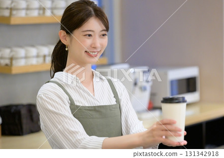 Female staff handing over coffee 131342918