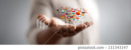 Open hand of a businessman holding numerous national flags, symbolizing international business, fostering global communication, and promoting world partnership across diverse cultures 131343147
