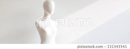 White female mannequin dressed in a white turtleneck top against a minimalist white background, featuring soft natural light for a clean, modern aesthetic 131343541