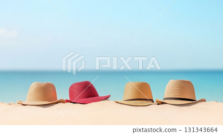 Four colorful summer hats are resting on a pristine sandy beach with a beautiful turquoise ocean and clear blue sky in the background, evoking a sense of relaxation and vacation 131343664