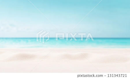Soft white sand creates a tranquil foreground against a backdrop of vibrant turquoise ocean water, blurred for effect, under a clear blue sky, evoking a serene and idyllic summer beach scene 131343721