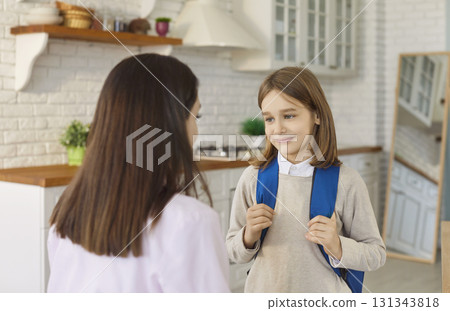 Mother and son prepare in morning before first day of school, standing together in home kitchen 131343818