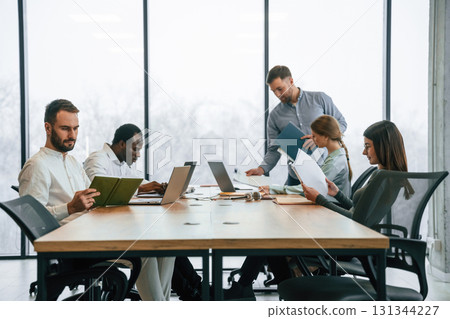 Bunch of laptops on the table. Team of office workers are together indoors 131344227