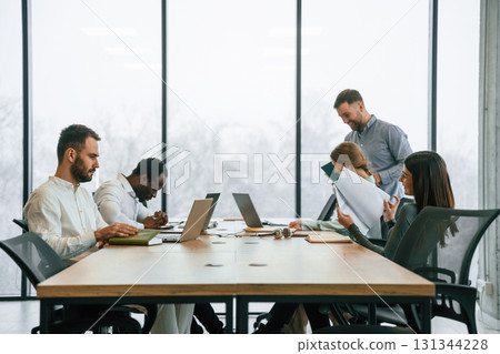 Bunch of laptops on the table. Team of office workers are together indoors 131344228