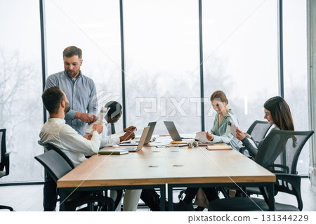 Bunch of laptops on the table. Team of office workers are together indoors 131344229