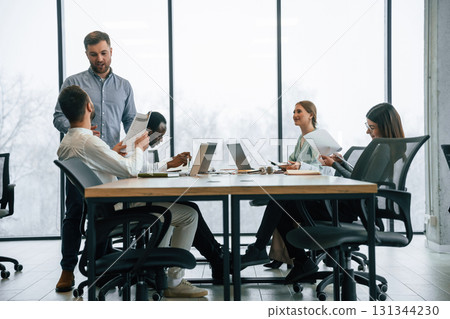 Bunch of laptops on the table. Team of office workers are together indoors Bunch of laptops on the table. Team of office workers are together indoors 131344230