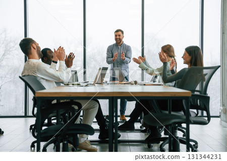 Applause, celebrate success. Team of office workers are together indoors 131344231