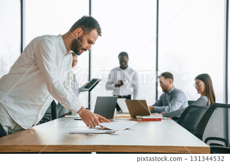 Team of office workers are together indoors Team of office workers are together indoors 131344532
