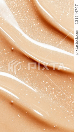Beige liquid foundation or bb cream flowing gracefully, creating mesmerizing smears and textures infused with glittering particles, illuminating and enhancing the skin's natural beauty 131344747
