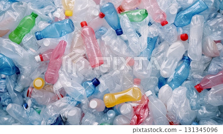 Plastic bottles of different colors and shapes are accumulating, creating a significant visual representation of the global environmental pollution caused by plastic waste 131345096