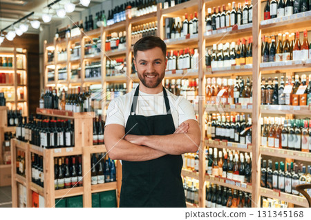 Wine shop owner in white shirt and black apron 131345168