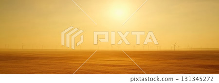 Golden sunlight illuminating a misty landscape with wind turbines generating sustainable energy, capturing the essence of renewable resources during a hazy sunrise or sunset 131345272