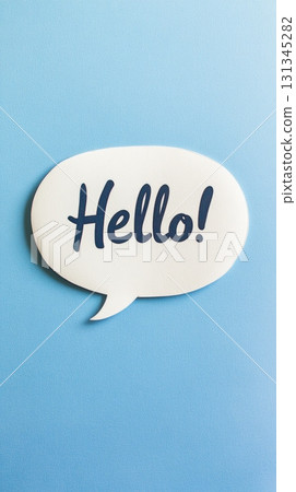 White speech bubble with the word hello written in blue sits on a light blue background, representing communication, greeting, and online messaging 131345282