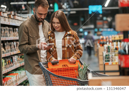 Beautiful people. Young couple are in supermarket together Beautiful people. Young couple are in supermarket together 131346047
