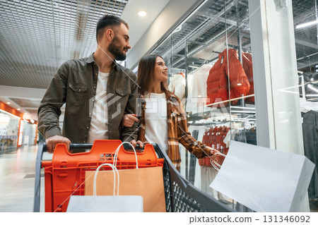 Buy me new clothes. Young couple are in supermarket together 131346092