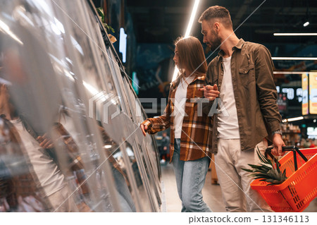 Young couple are in supermarket together Young couple are in supermarket together 131346113