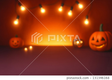 Blurred Pumpkins with carved faces and glowing candles on a table with orange lights in background. Halloween holiday decoration. soft focus backdrop with copy space. Design for banner, 131346168