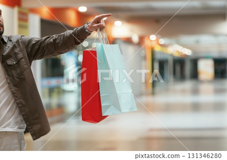 Close up view, holding shopping bags. Man is shopping in the supermarket Close up view, holding shopping bags. Man is shopping in the supermarket 131346280