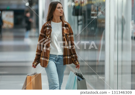 In the corridor. Woman is shopping in the supermarket In the corridor. Woman is shopping in the supermarket 131346309