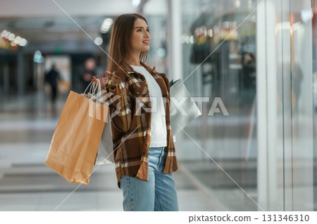 In the corridor. Woman is shopping in the supermarket 131346310