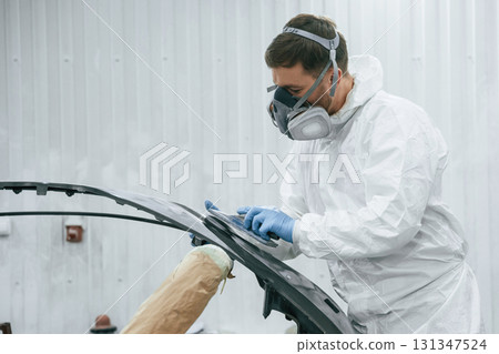 Metal carcass. Repairman is working in the garage 131347524