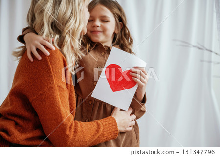 Conception of mother's day celebration. Parent with daughter at home Conception of mother's day celebration. Parent with daughter at home 131347796