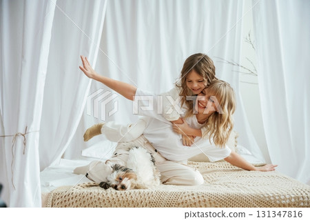 Wellness, having fun on the bed. Mother with daughter are at home together Wellness, having fun on the bed. Mother with daughter are at home together 131347816