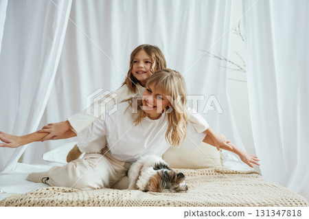 Wellness, having fun on the bed. Mother with daughter are at home together Wellness, having fun on the bed. Mother with daughter are at home together 131347818