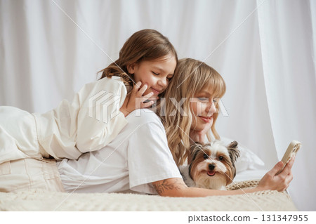 Cute dog is with them. Mother with daughter are at home together Cute dog is with them. Mother with daughter are at home together 131347955